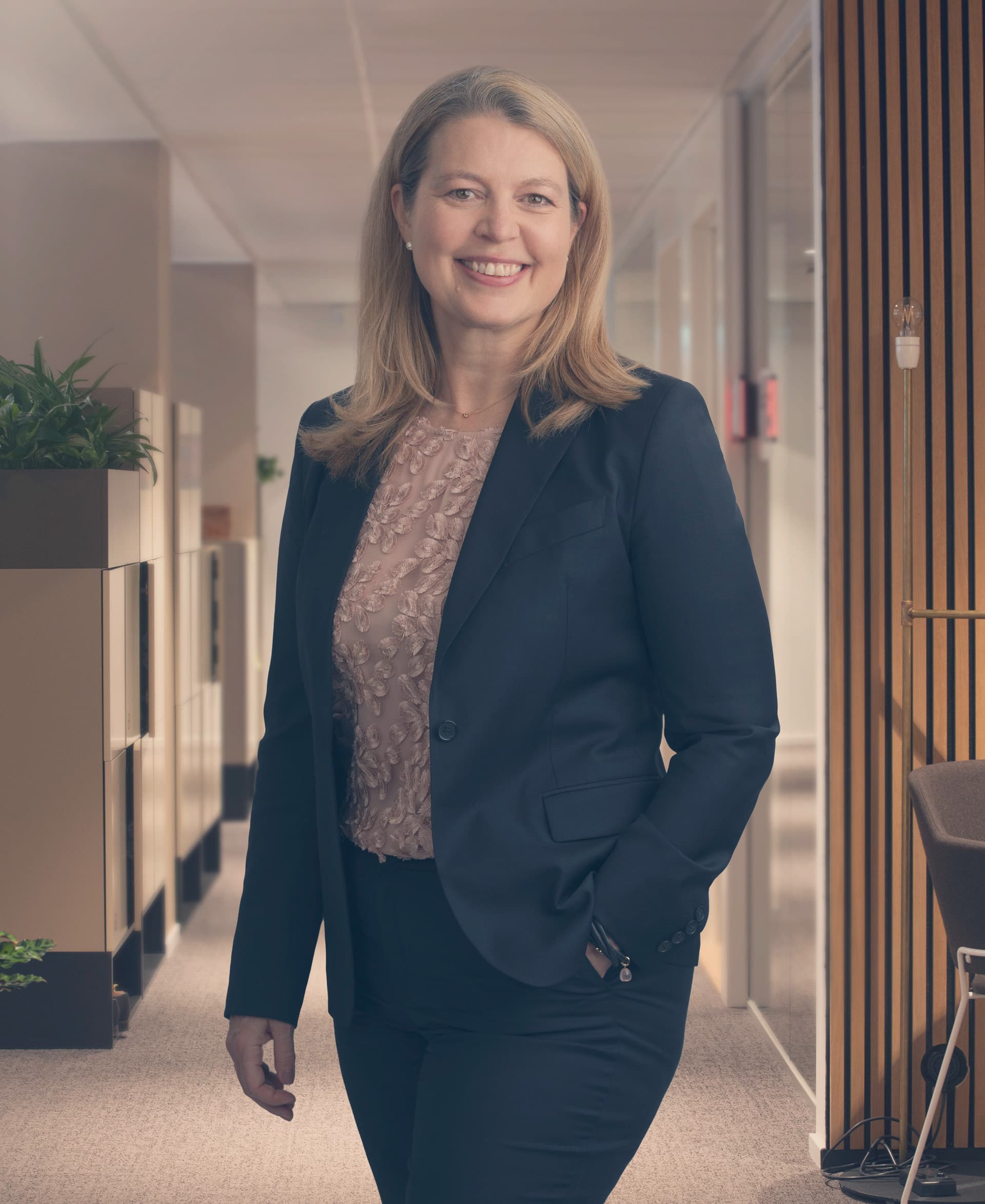 Maria Håkansson, Chief Executive Officer at Swedfund, standing in the office smiling