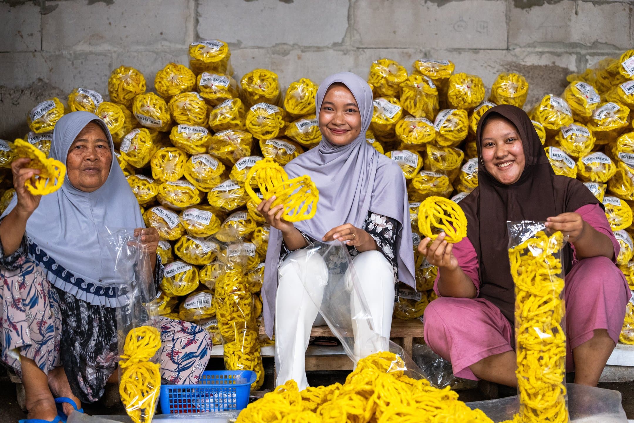 Three women sit at a table and discuss