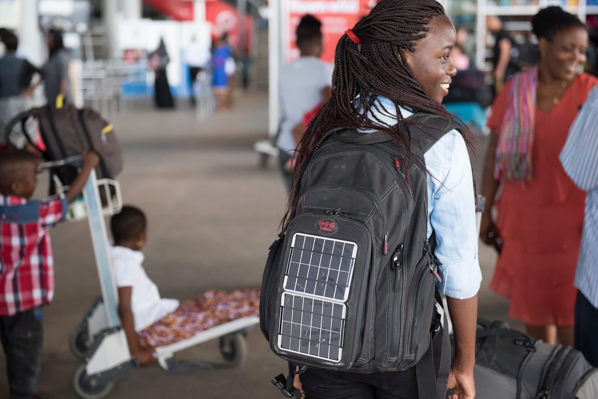 Woman carrying a backpack with a solar cell