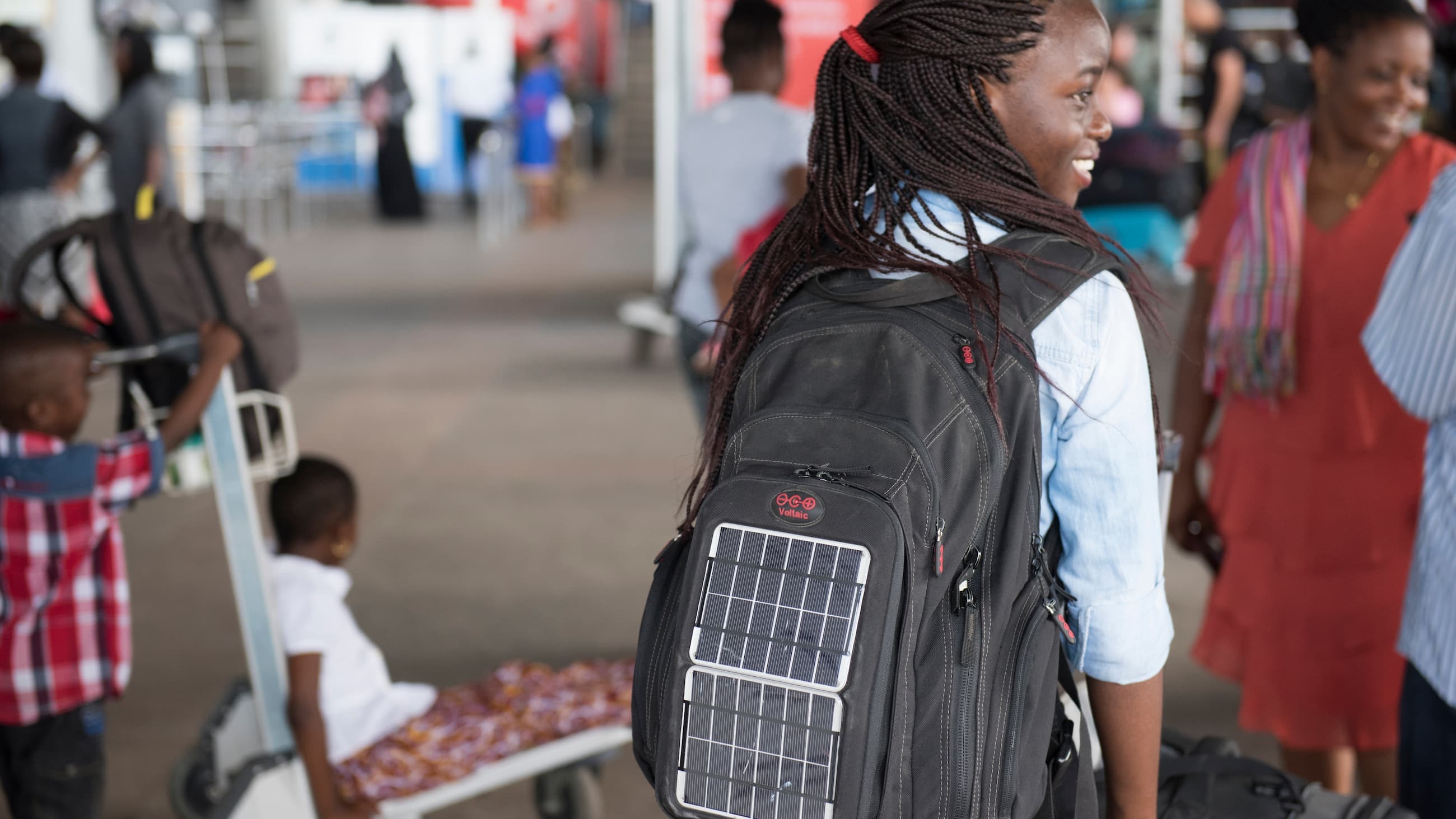 Girl carries backpack with solar cell 